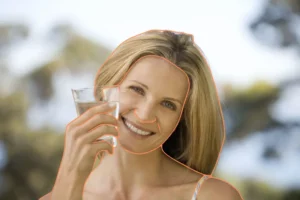 Joyful Woman Enjoying organic Zinc Sulfate in Water